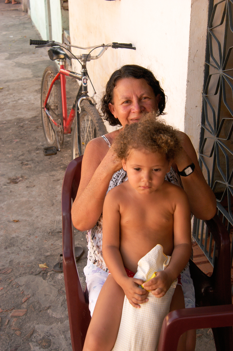 Grandma removing lice from hair, Barreirinhas, MA