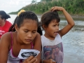 Milagro reading the Chick Tract, that we distributed to adults, during the canoe ride to Samaria